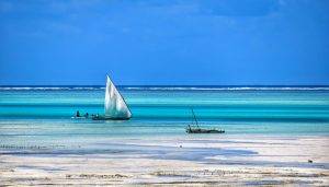 Low tide in Zanzibar, a blue sea and a couple of boats